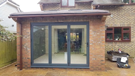 Aluminium bi-folding doors installed by Village Windows